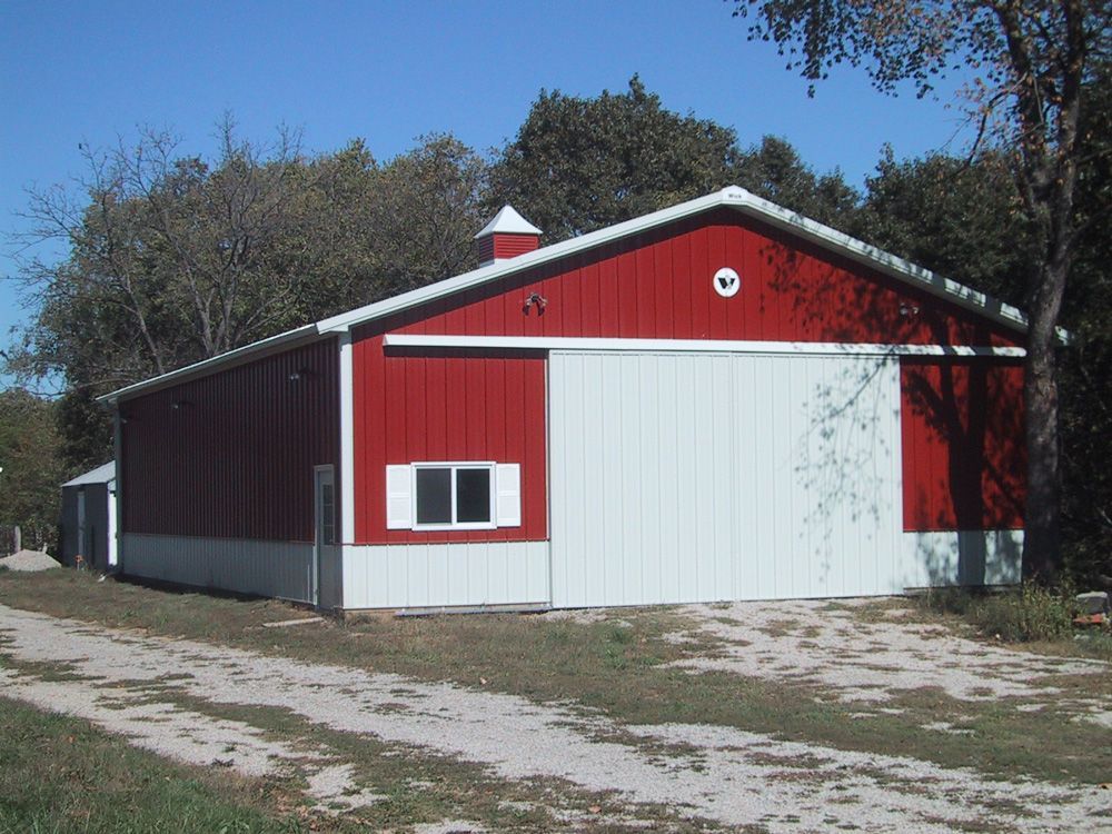 A red and white barn with a white door