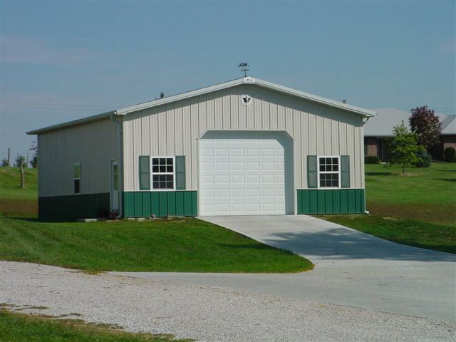 A garage with a white door and green trim
