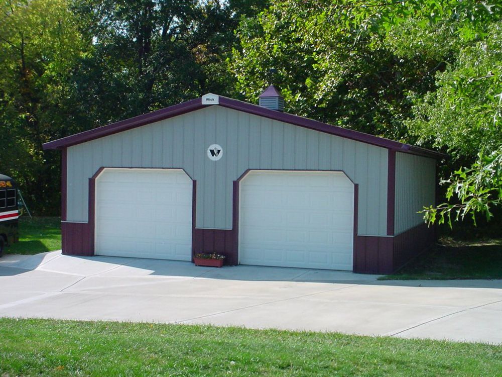 A gray and purple garage with a white door