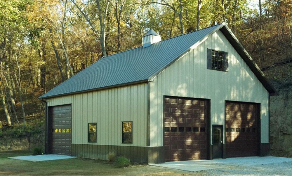A garage with a gray roof and brown garage doors