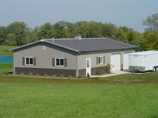 A house with a trailer parked in front of it.