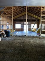 The inside of a building under construction with a lot of windows.