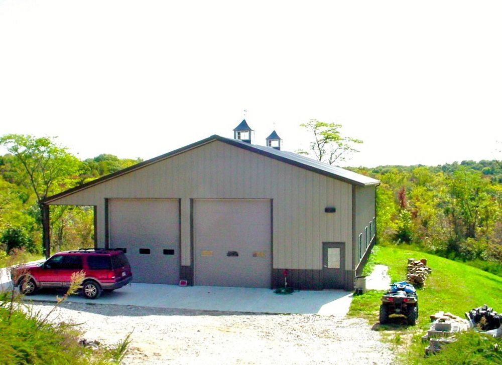 A garage with a red suv parked in front of it