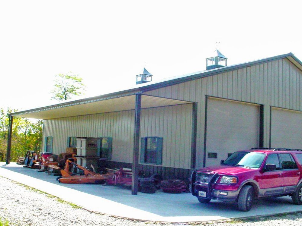 A red suv is parked in front of a building