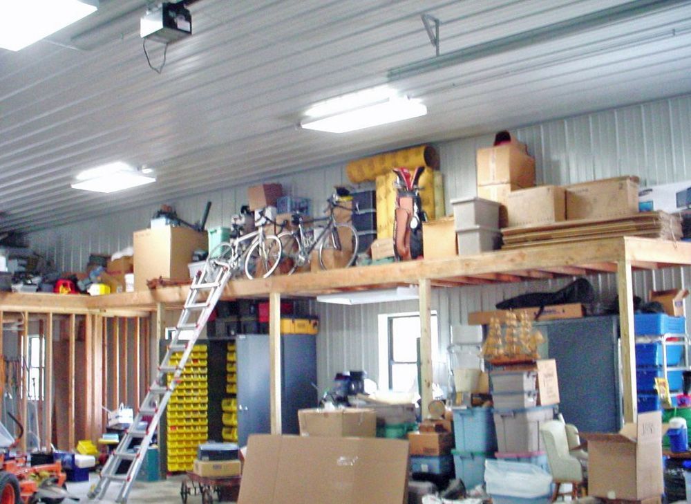 A garage filled with lots of boxes and a ladder