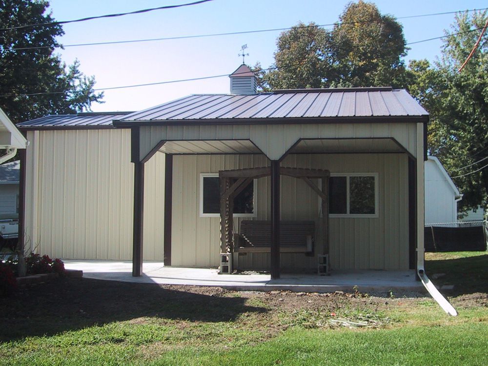 A small house with a covered porch and a metal roof