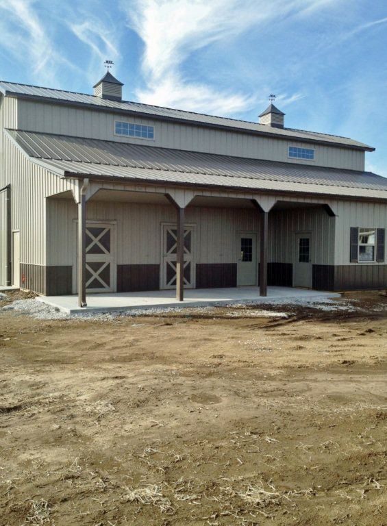 A large building with a porch and a blue sky in the background