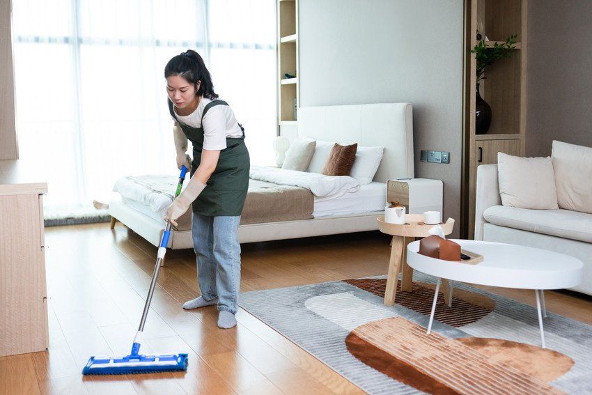 Female Cleaning Floor With Mop