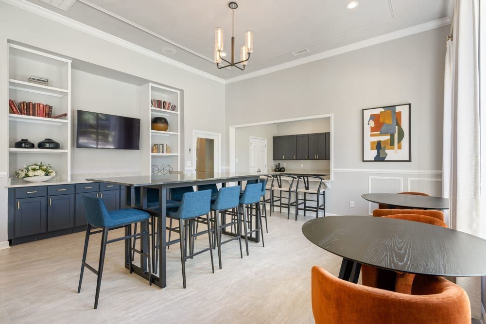 a large room with tables and chairs in it at Marquis Carmel Valley in Charlotte, NC.
