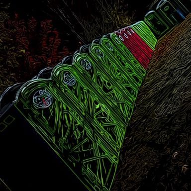 Green and red Eiffel Tower detail against a dark, textured background.