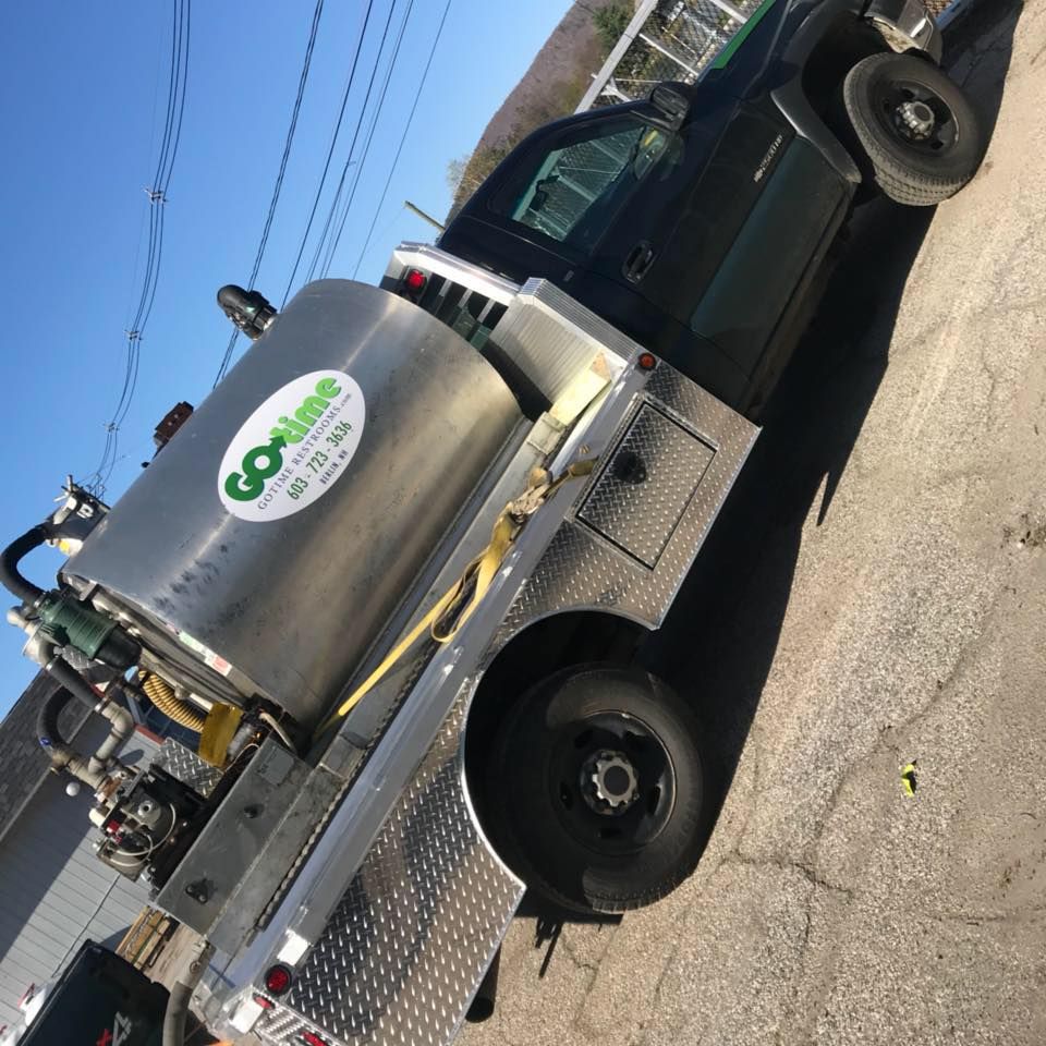 Black pickup truck with a large silver tank, labeled 