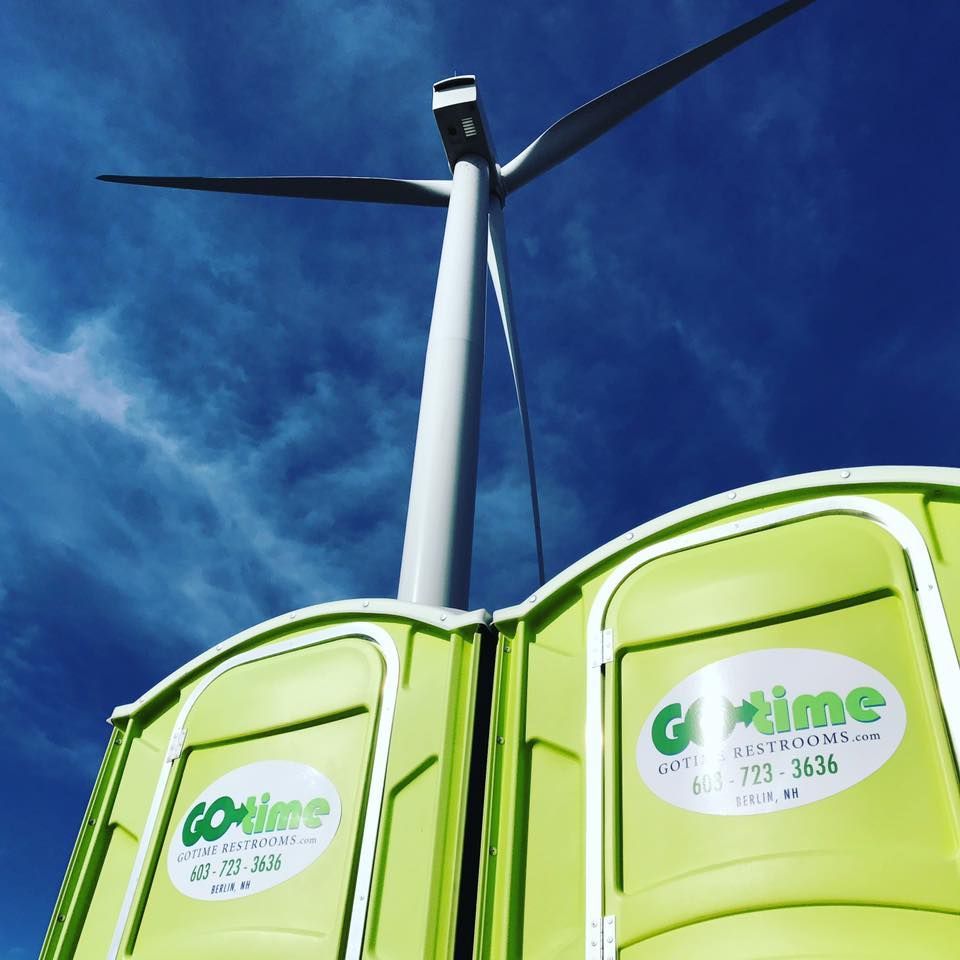 Two lime-green portable toilets, labeled