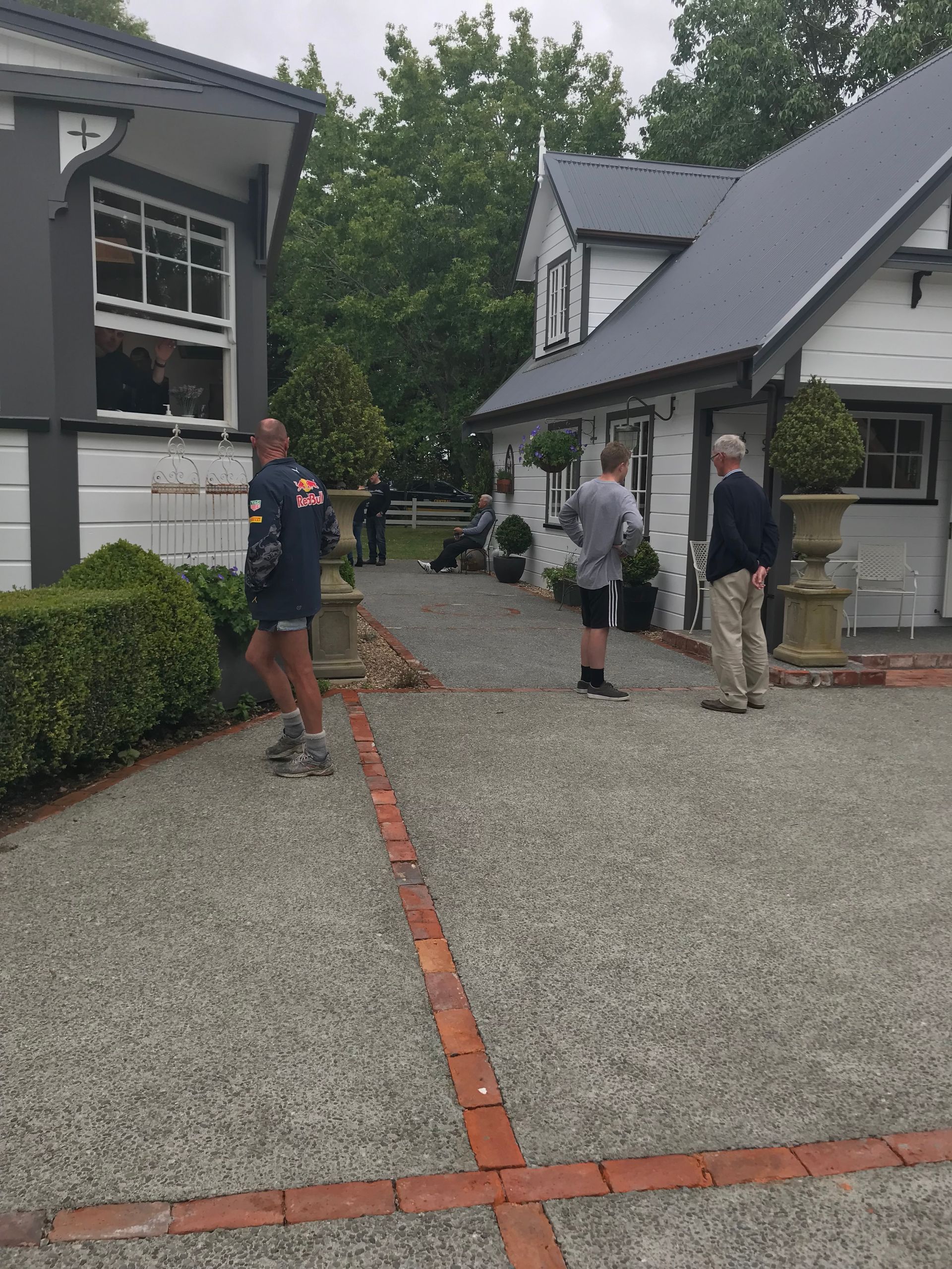 A group of people are standing in front of a house