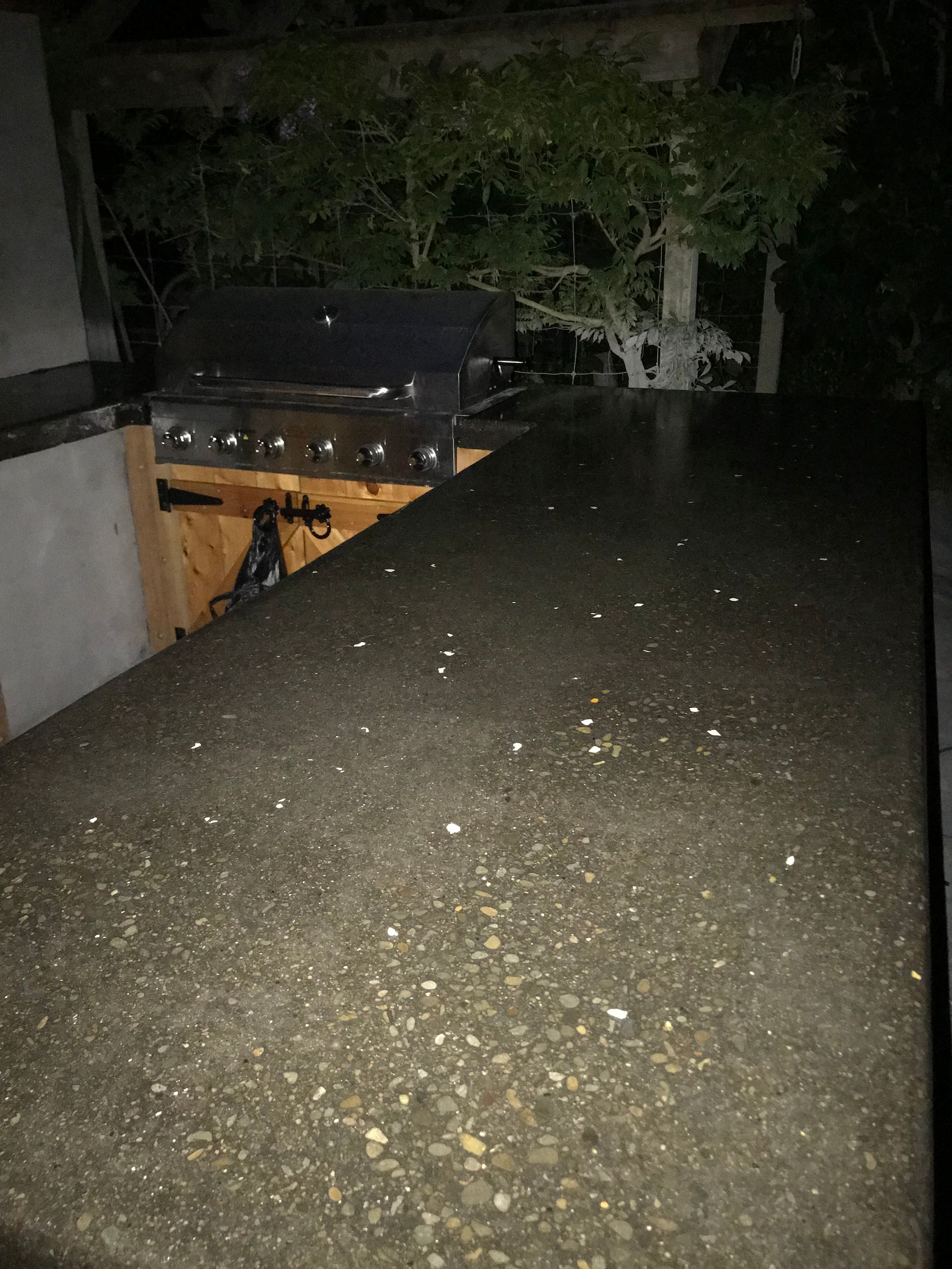 A grill is sitting on top of a counter in a dark room.