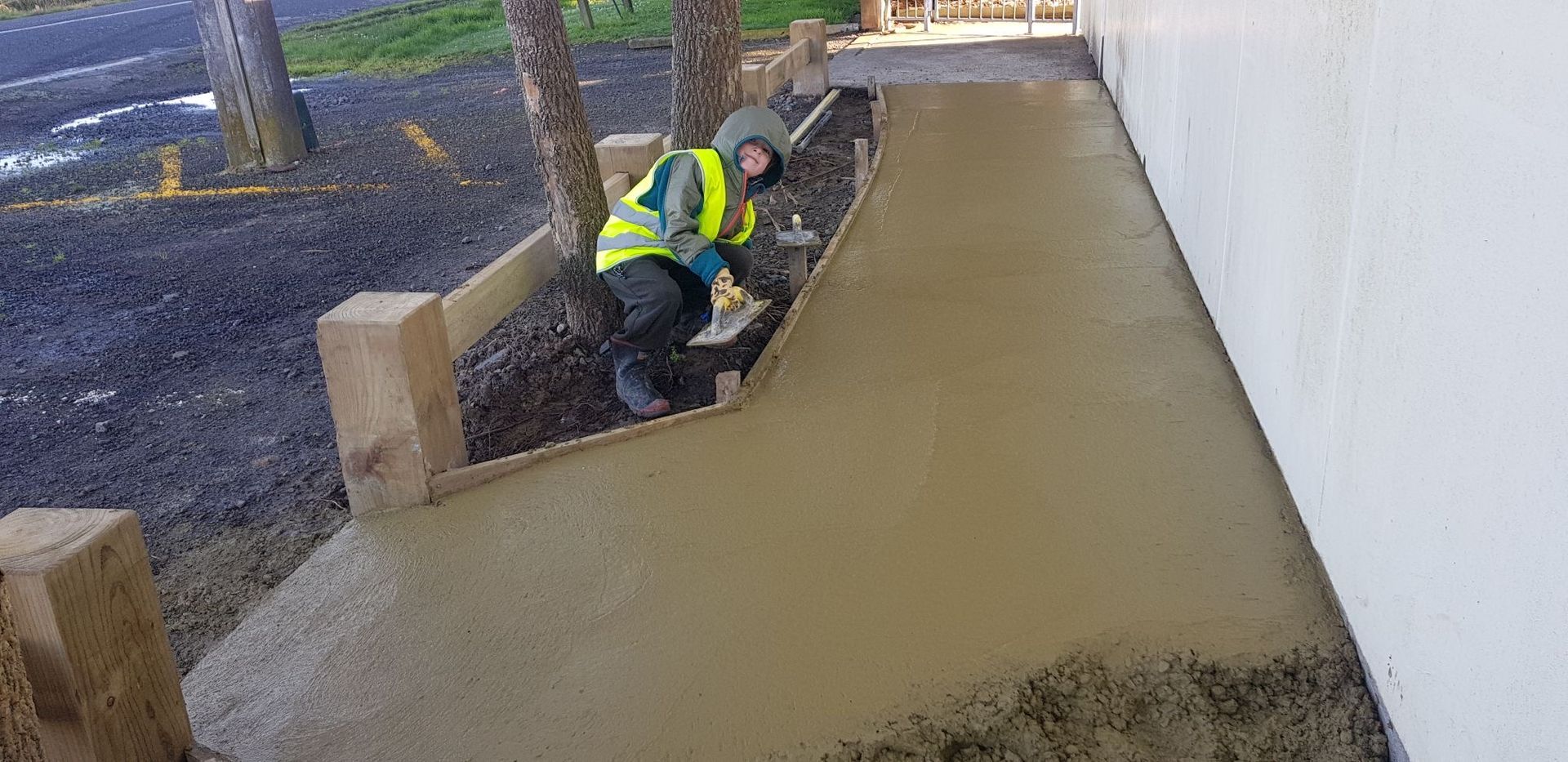 A man is working on a concrete ramp.