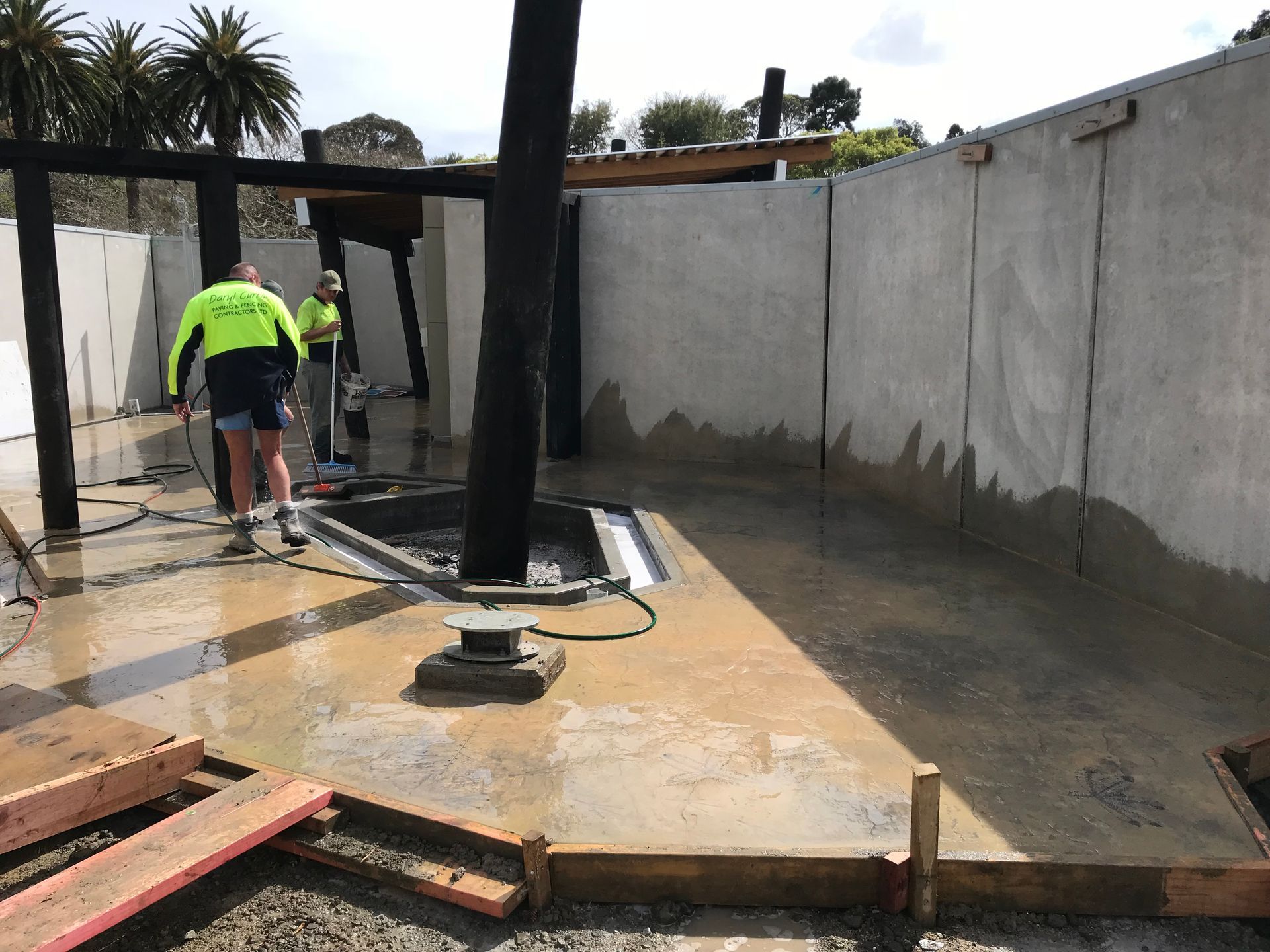 A group of construction workers are working on a concrete floor.