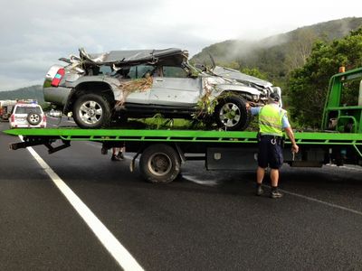 Policeman Inspecting Car after Wreck - Towing Services in Mount Sheridan, QLD