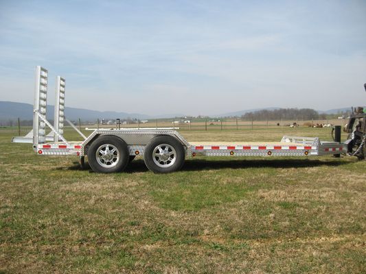 A trailer is parked in a grassy field.