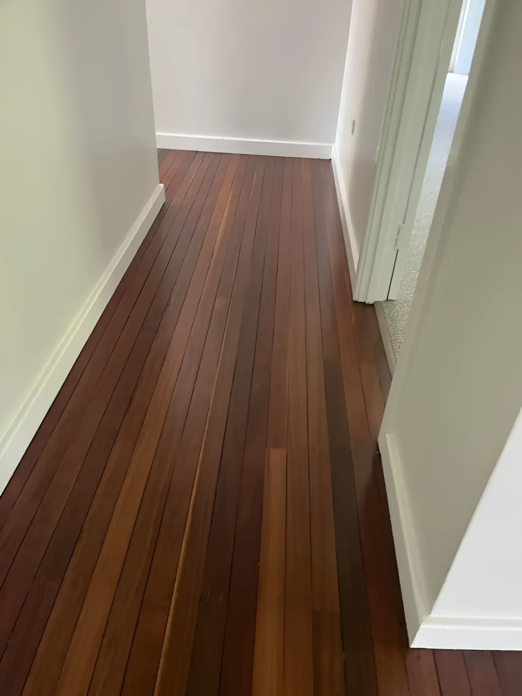 Wooden Floor Hallway with White Walls and Trim — Toowoomba Polished Floors in Gatton, QLD