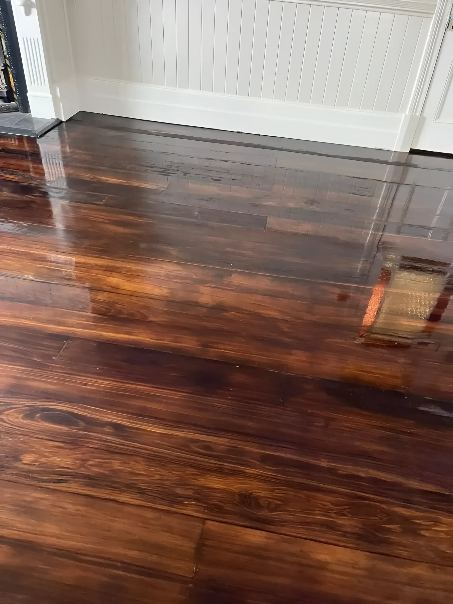 Shiny Brown Wooden Floor Reflecting Light Near White Trim — Toowoomba Polished Floors in Clifton, QLD