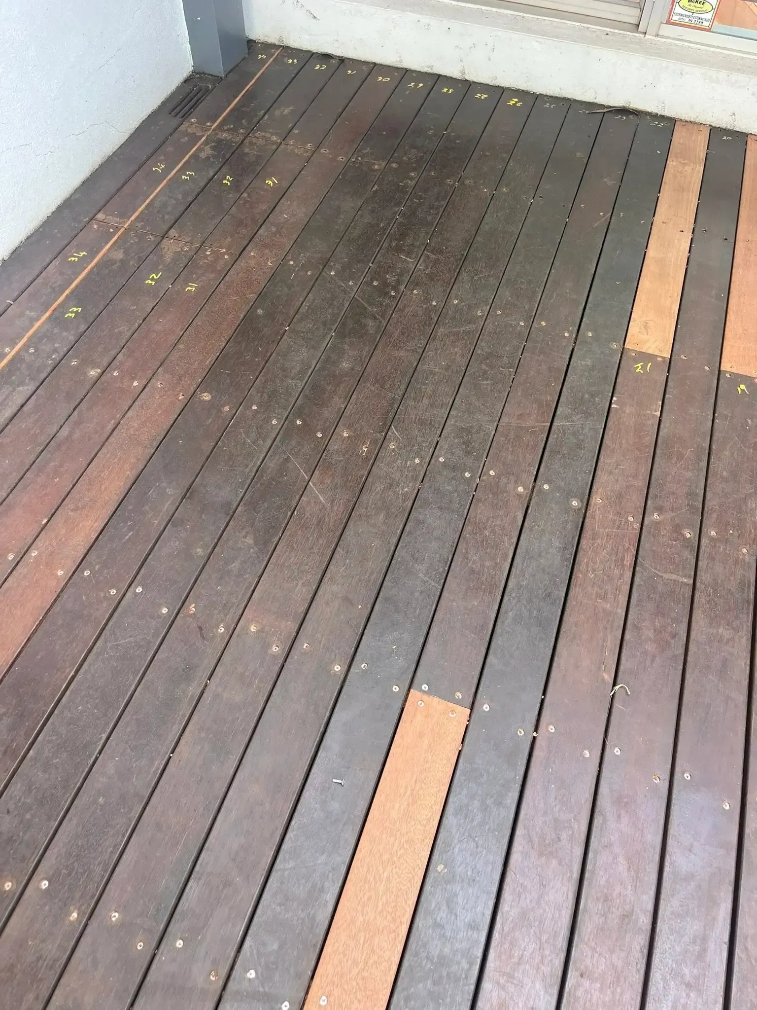 Wooden deck with varying shades of brown and orange, showing lines and small holes. — Toowoomba Polished Floors in Clifton, QLD