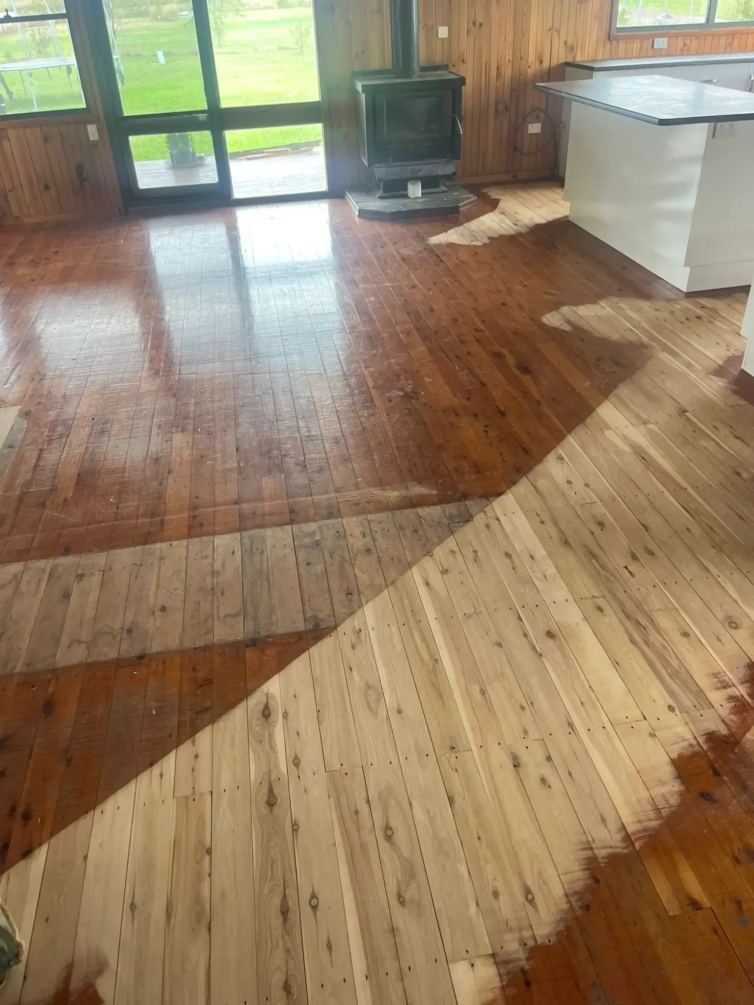 Wooden floor partially sanded and refinished, showing the difference in color and texture. — Toowoomba Polished Floors in Dalby, QLD