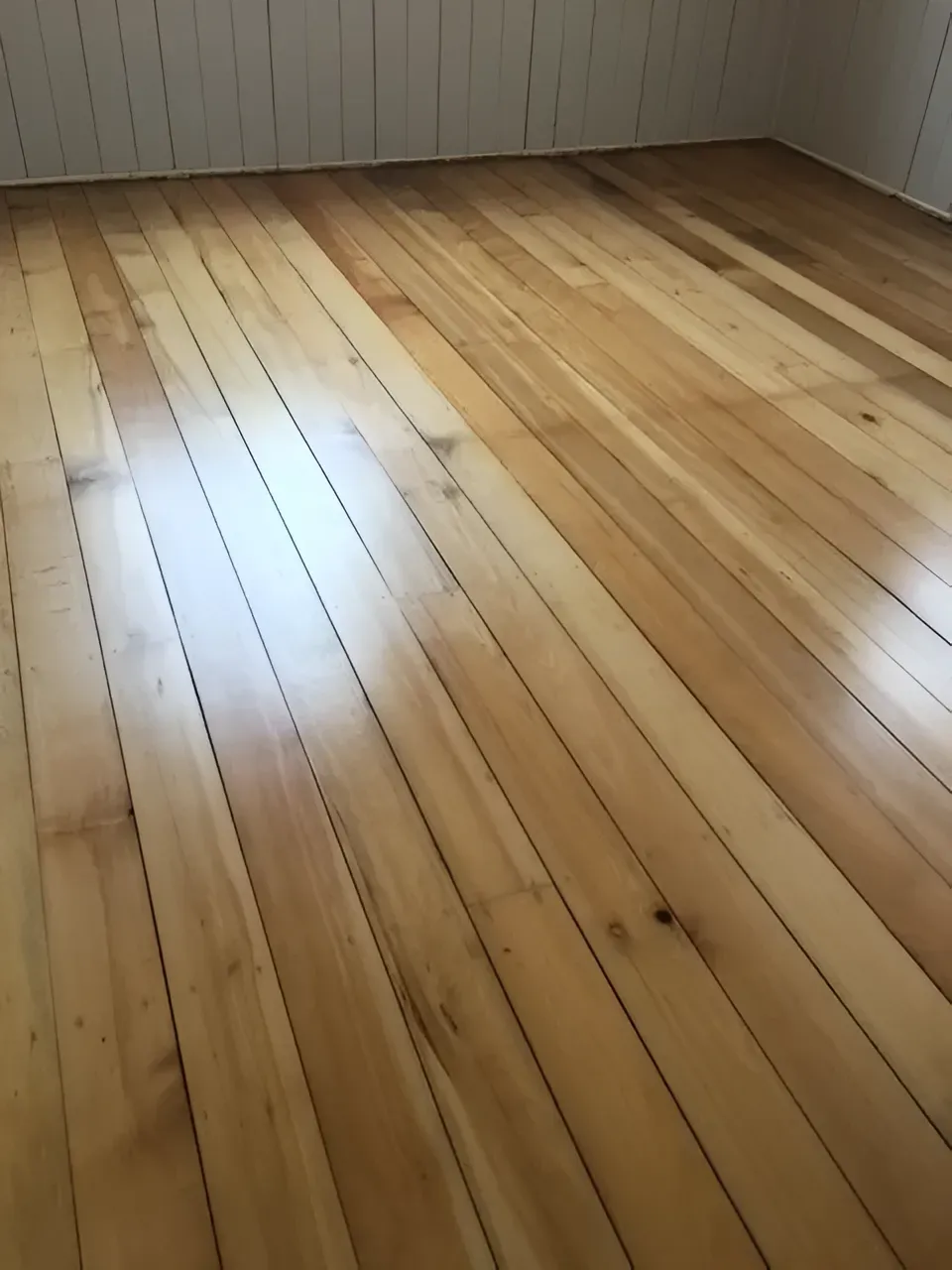 Wooden Floorboards in A Room Light Brown with Knots and Grain — Toowoomba Polished Floors in Toowoomba, QLD