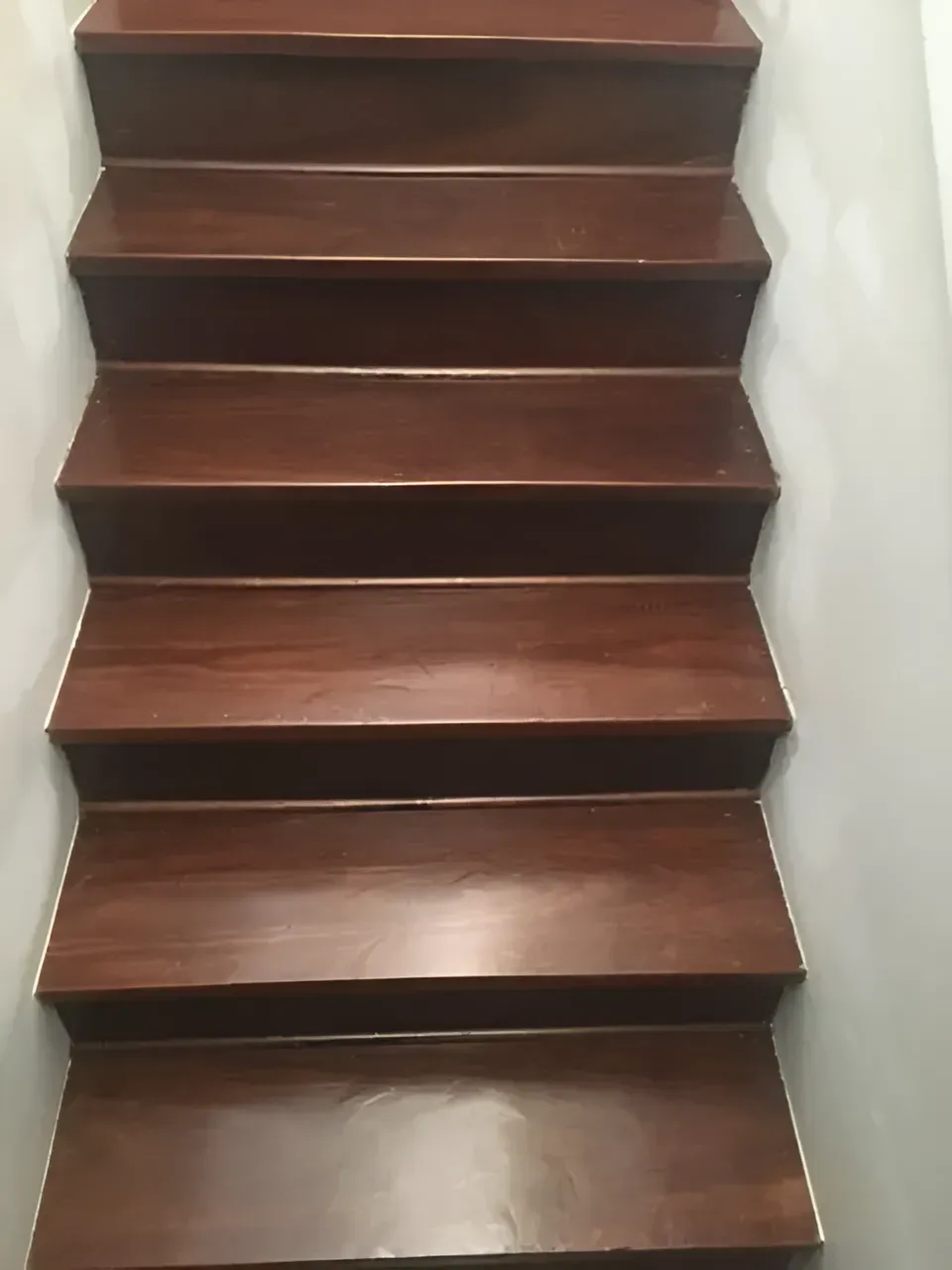 Wooden Stairs With a Brown Finish Between White Walls — Toowoomba Polished Floors in Toowoomba, QLD