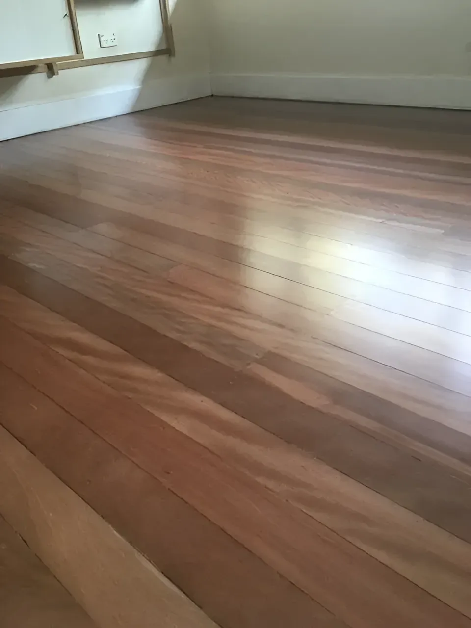 Wooden Hardwood Floor Varying Shades of Brown in An Empty Room — Toowoomba Polished Floors in Toowoomba, QLD