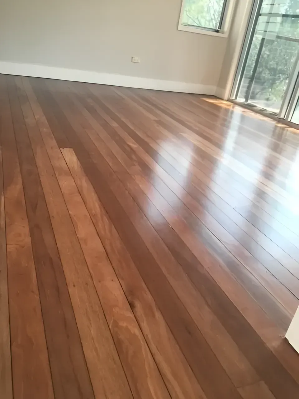 Polished Hardwood Floor Reflecting Sunlight from A Large Window — Toowoomba Polished Floors in Toowoomba, QLD
