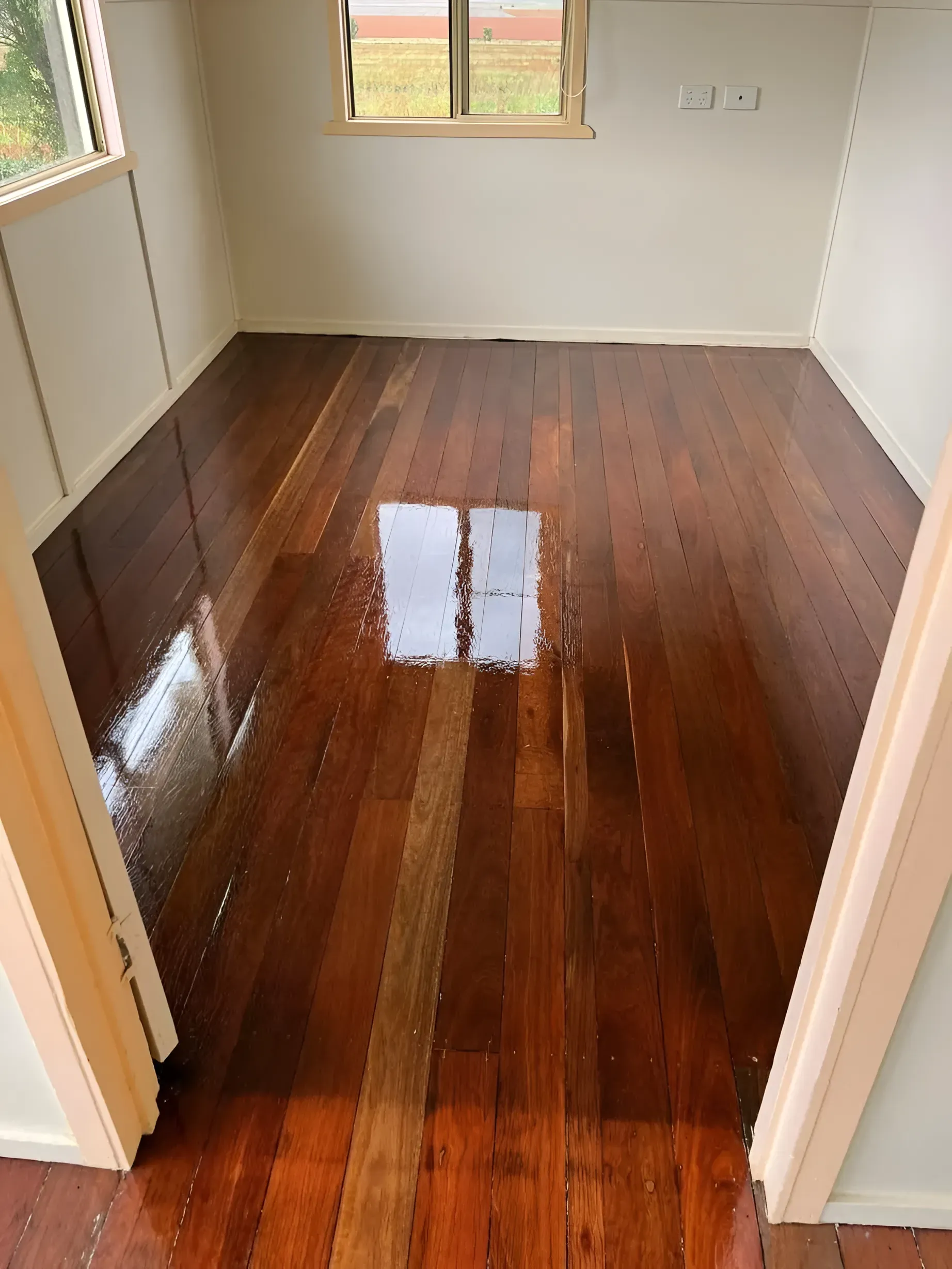 Newly Varnished Hardwood Floor in A Small Room with Light-Colored Walls — Toowoomba Polished Floors in Esk, QLD