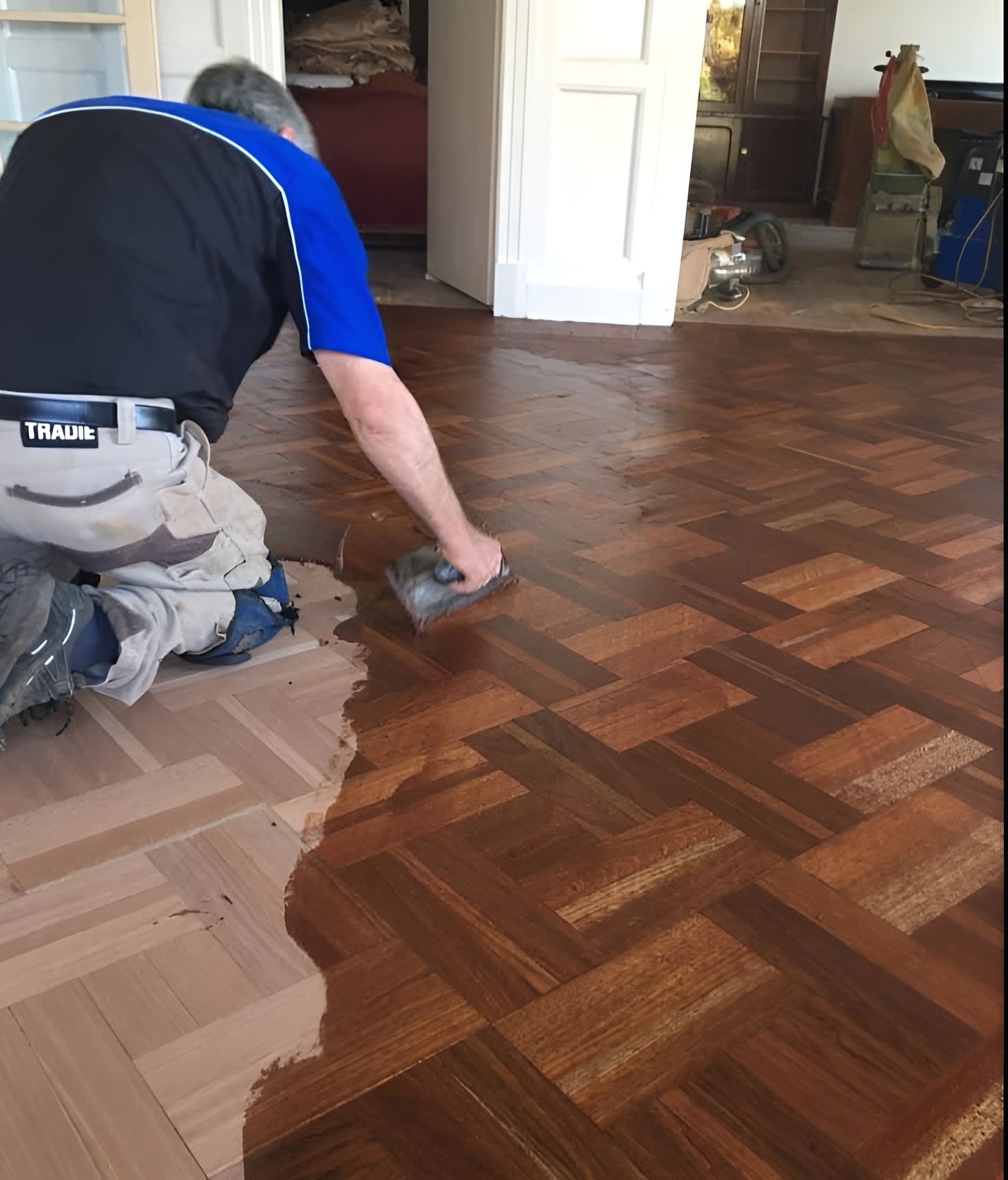 Man Applying Finish to A Parquet Wood Floor — Toowoomba Polished Floors in Toowoomba, QLD