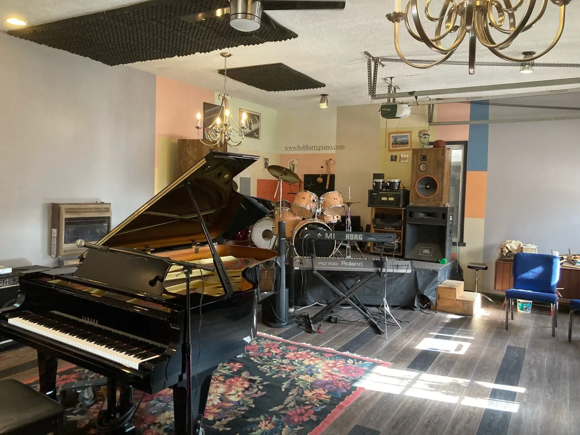 a large room with a piano and drums in it