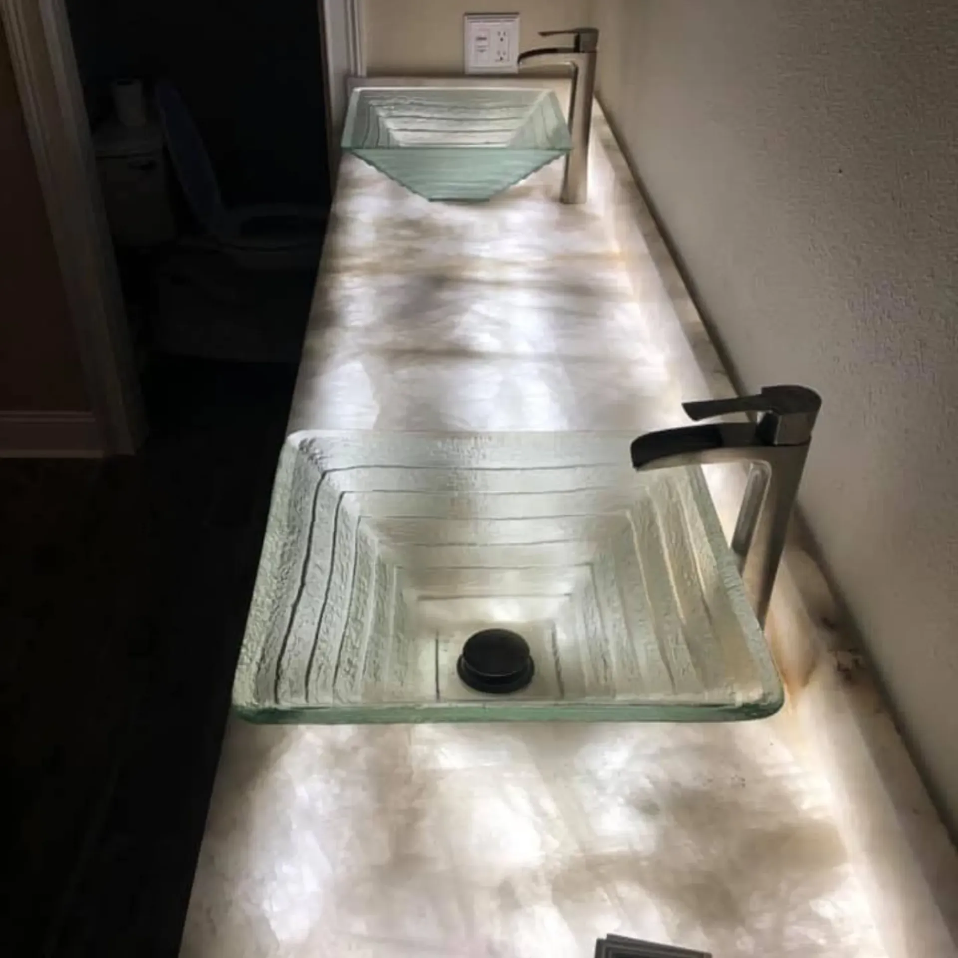 Service of Knights LLC - A bathroom counter with two sinks and a faucet.