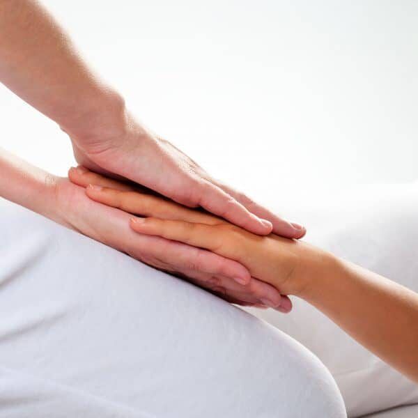 A reiki therapist in Austin performing healing through a reiki therapy session for gut healing