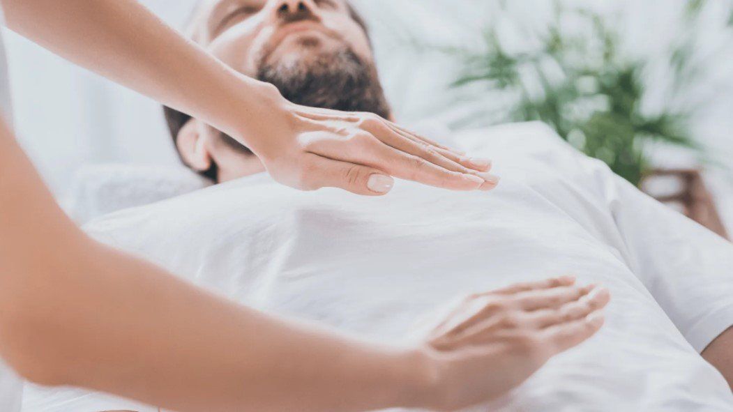a man undergoing reiki therapy from the best reiki therapist in Austin