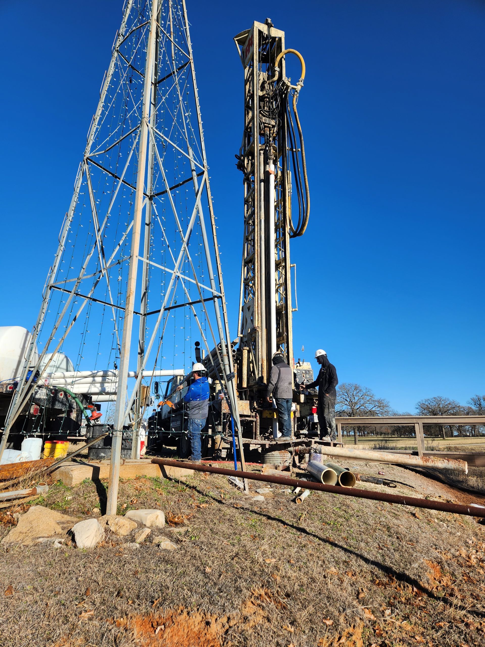 A group of men are working on a large machine in a field