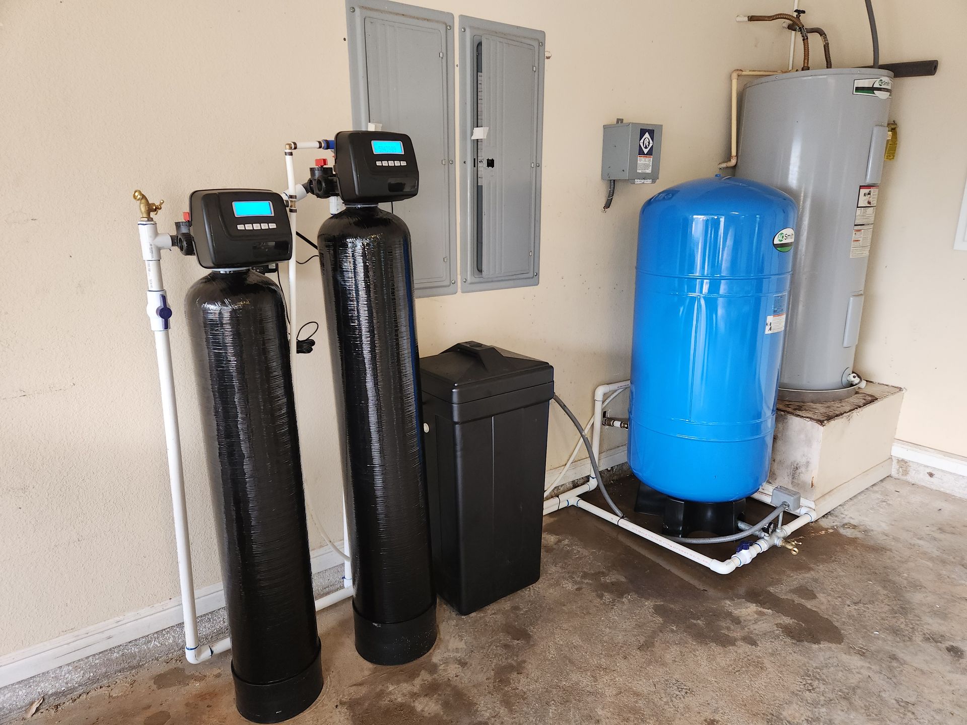 Two water filters and a water tank in a garage