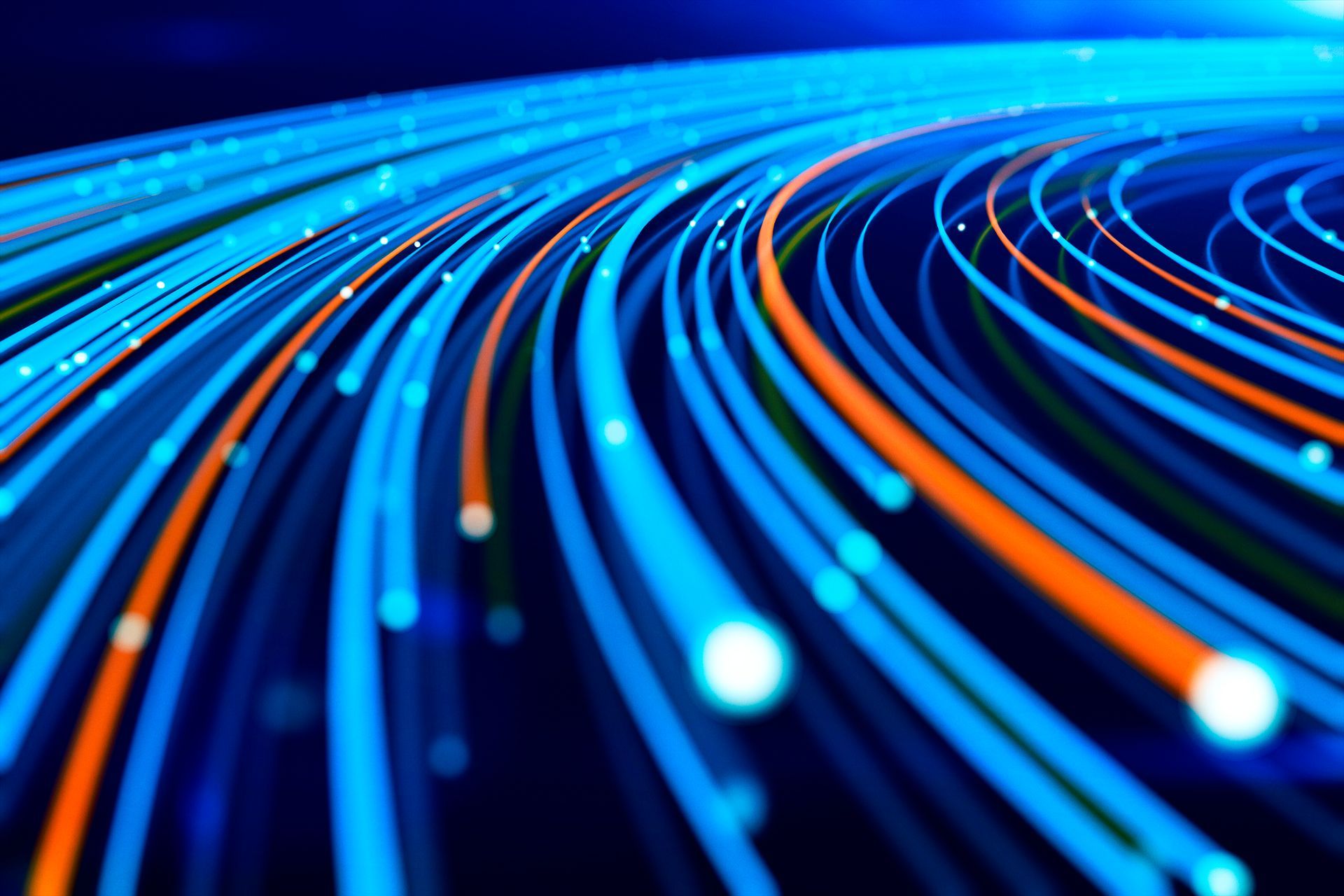 Le scie luminose blu e arancioni si curvano su uno sfondo blu scuro, raffigurando il flusso di dati.