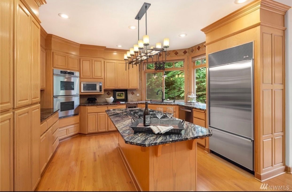 A kitchen with stainless steel appliances and wooden cabinets