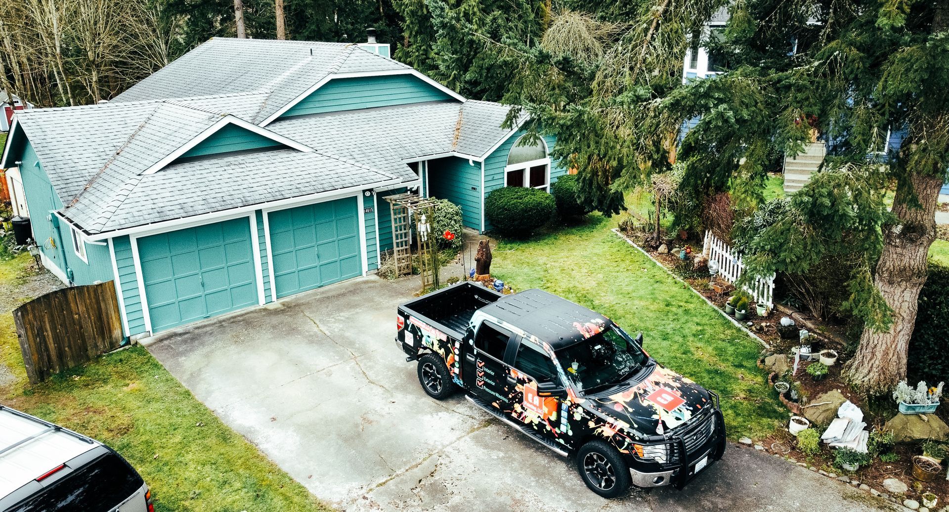 An aerial view of a truck parked in front of a house.