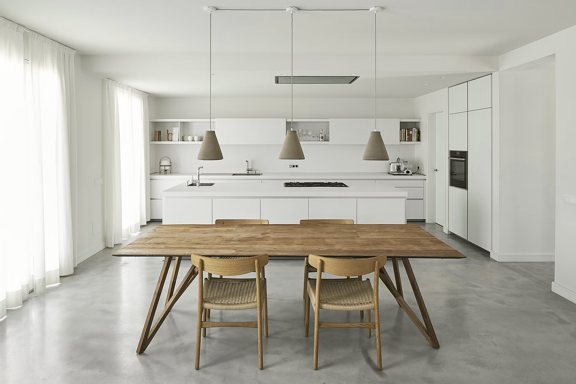 A kitchen with a wooden table and chairs in it