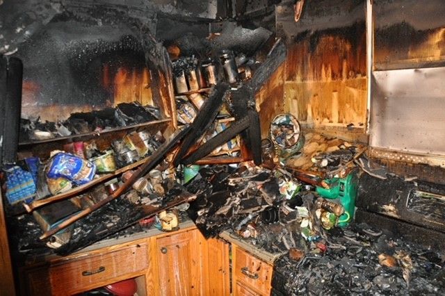 A kitchen that has been damaged by a fire.