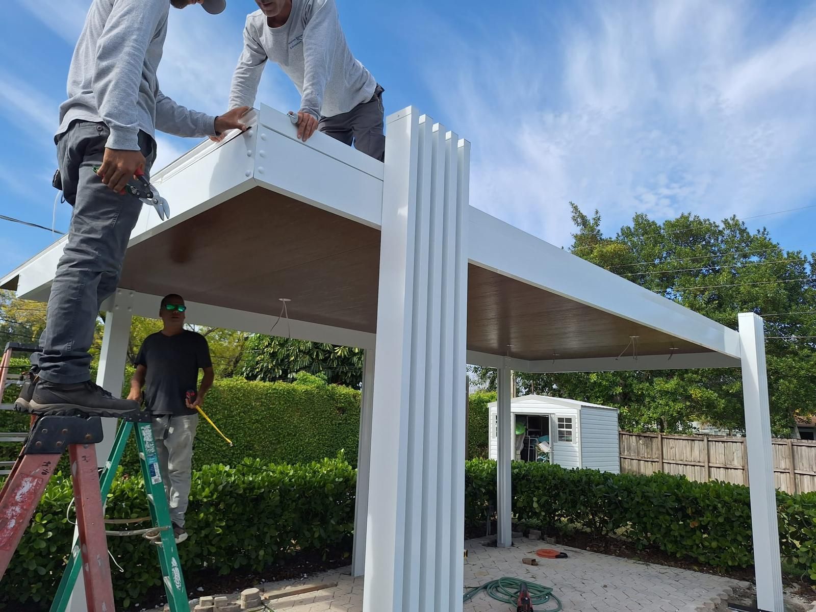 A group of men are working on a white structure.