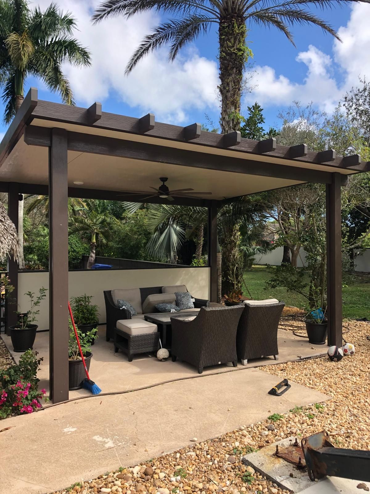 A pergola with a table and chairs underneath it