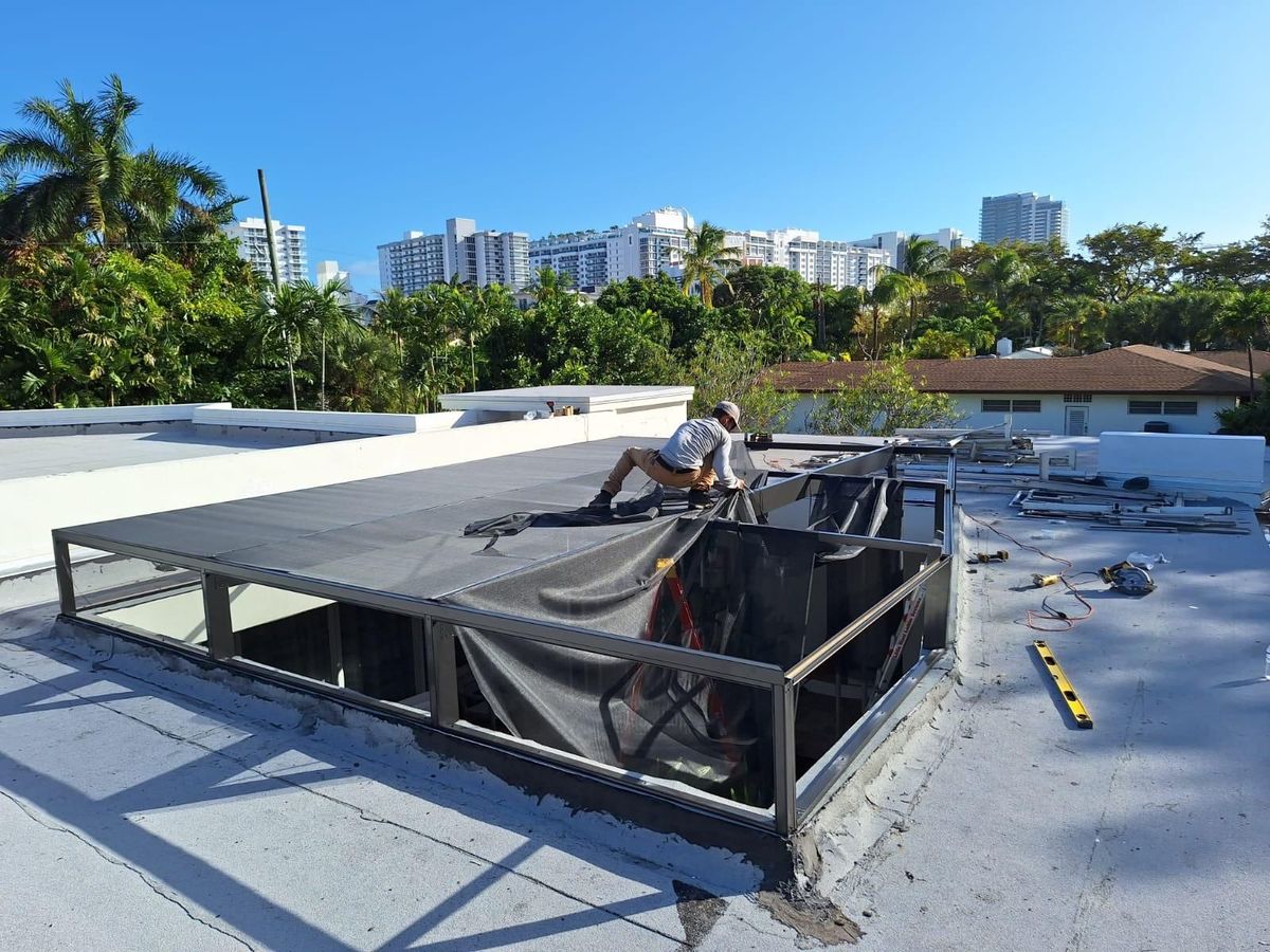 A man is working on the roof of a building.