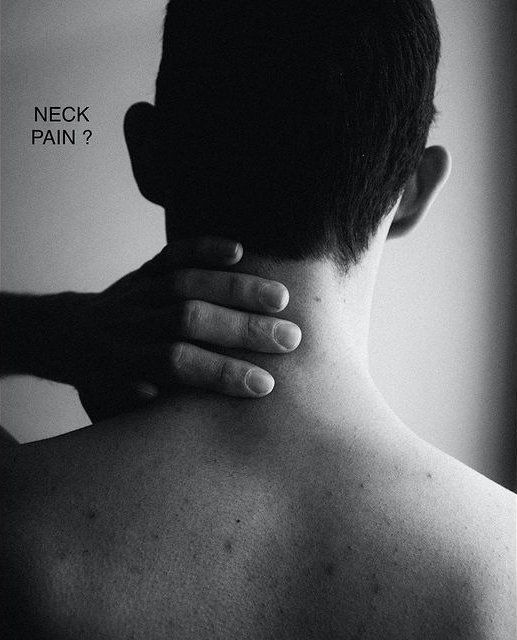 Person holding back of neck