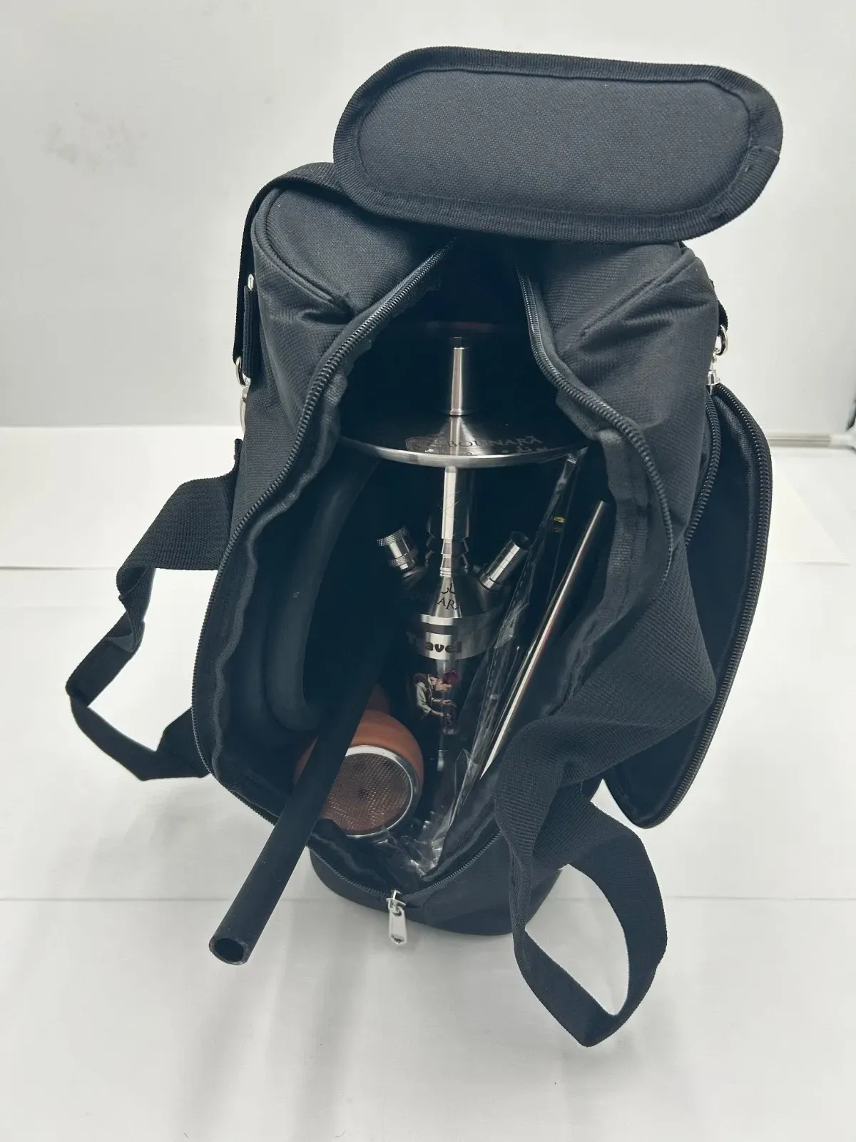 Black carrying bag open, revealing a hookah inside.