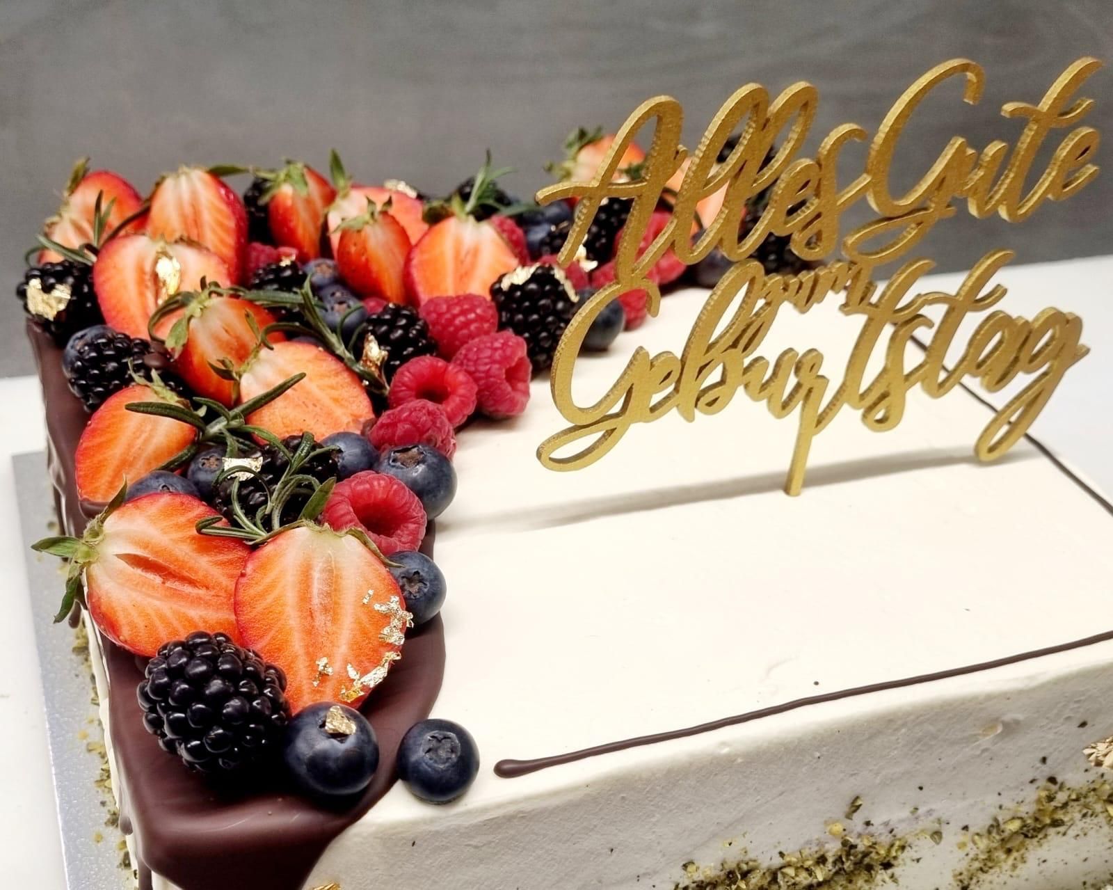 Birthday cake with fresh berries and gold 