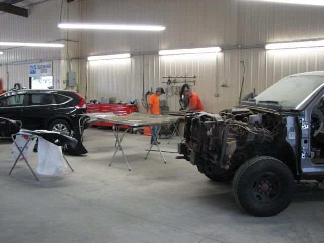 A man is working on a car in a garage